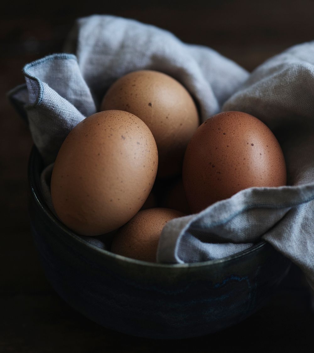 Fresh hen eggs on black background