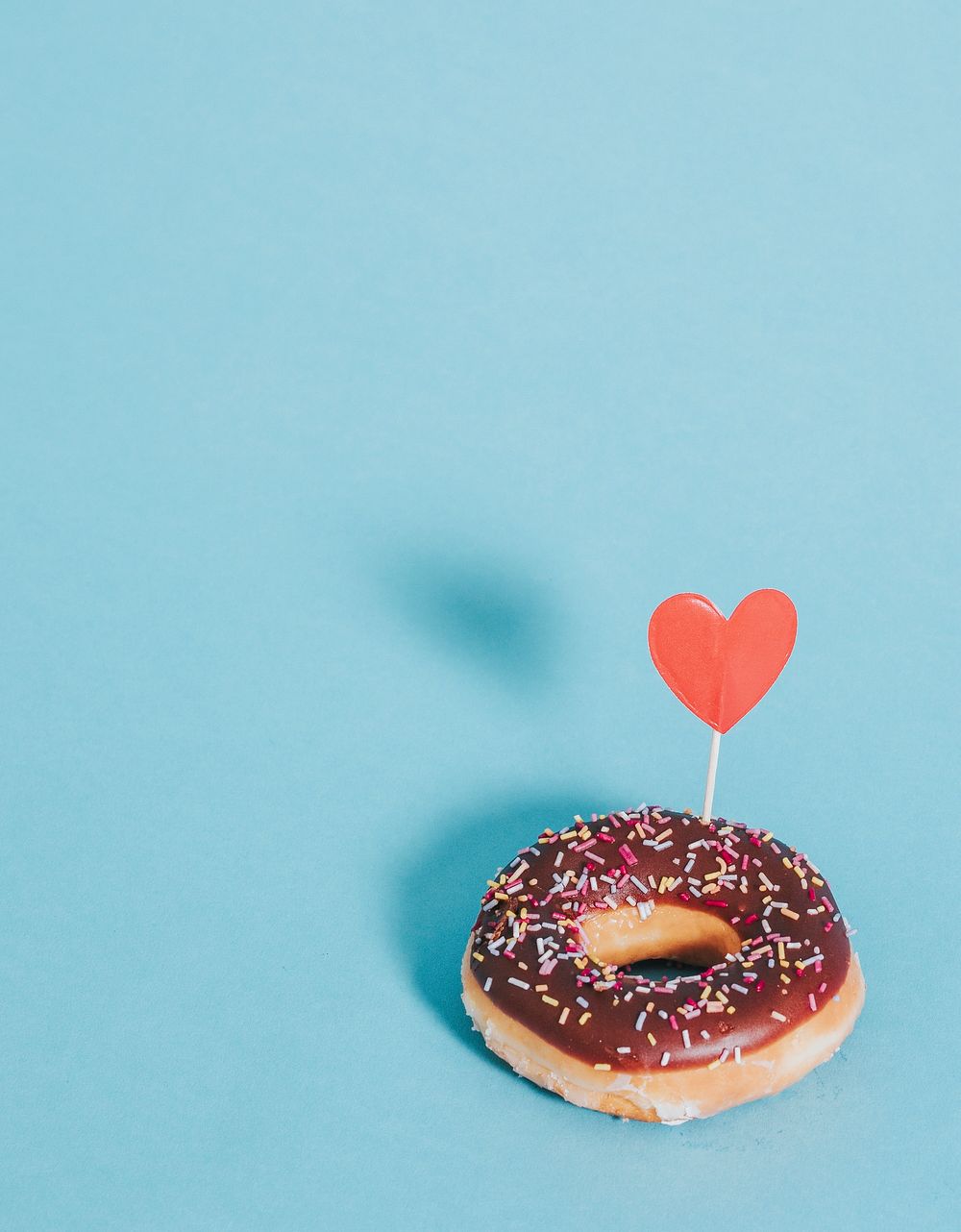 Tasty glazed donut decorated with a heart