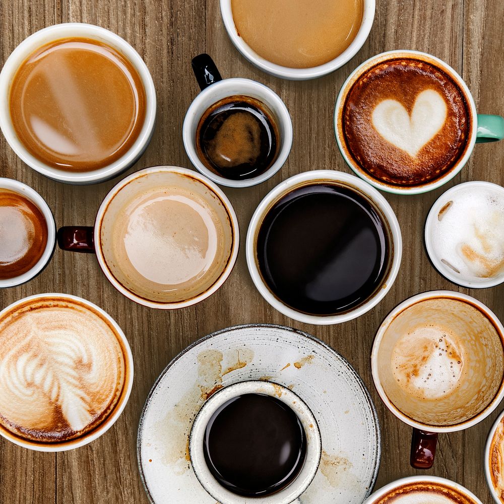 Mixed coffee mugs on a brown textured background