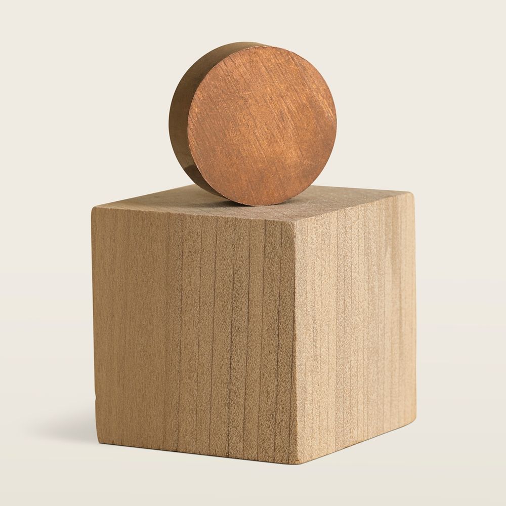 Round wooden object on brown wooden cubic