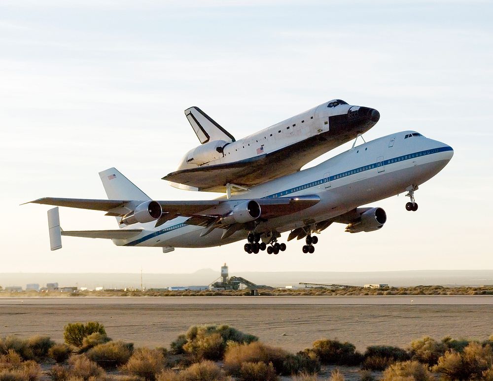 NASA's modified Boeing 747 Shuttle Carrier Aircraft with the Space Shuttle Atlantis on top lifts off from Edwards Air Force…