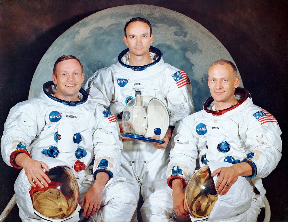 The official crew portrait of the Apollo 11 astronauts from left to right are: Neil A. Armstrong, Commander; Michael…