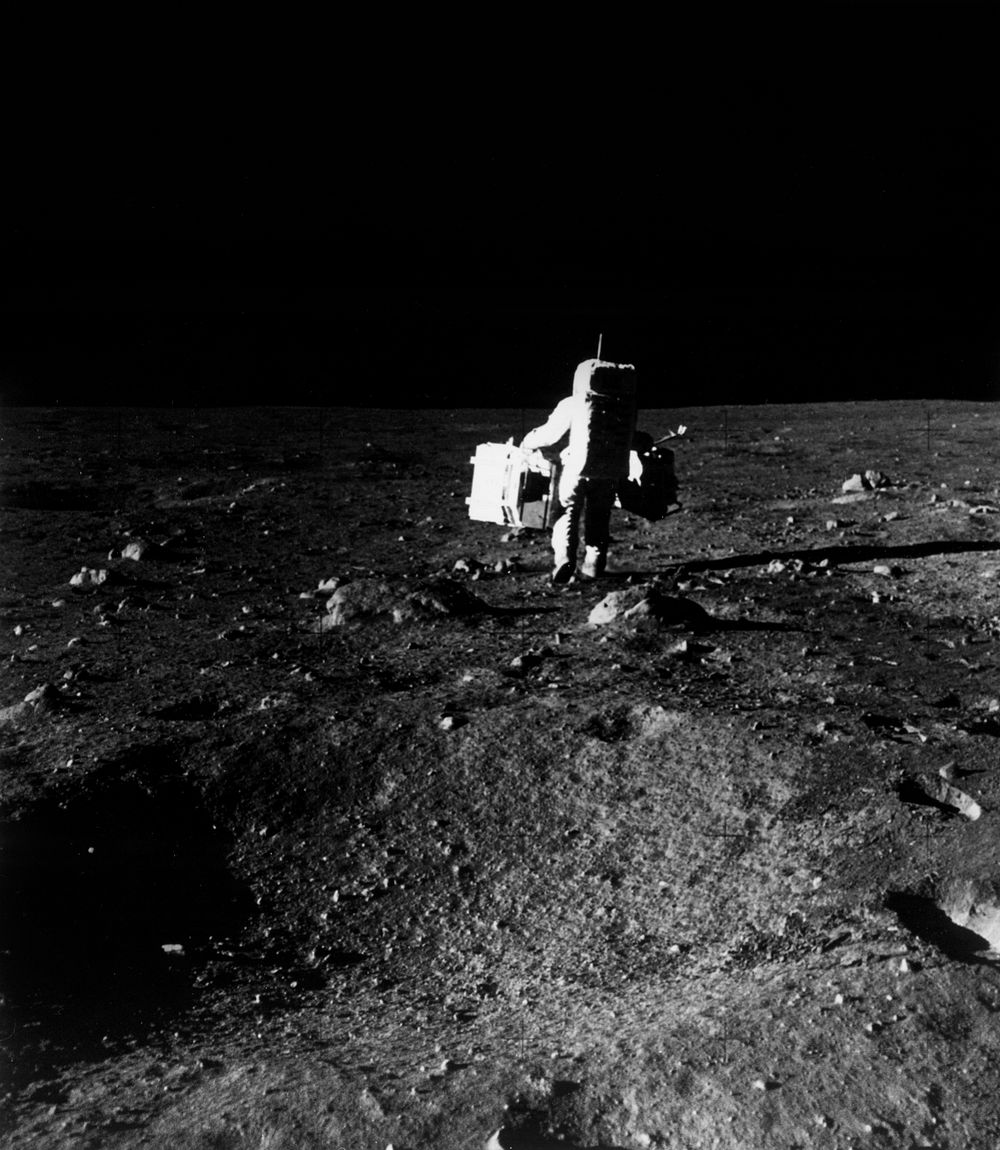 Astronaut Edwin E. Aldrin Jr., lunar module pilot, is photographed with scientific equipment. Original from NASA. Digitally…