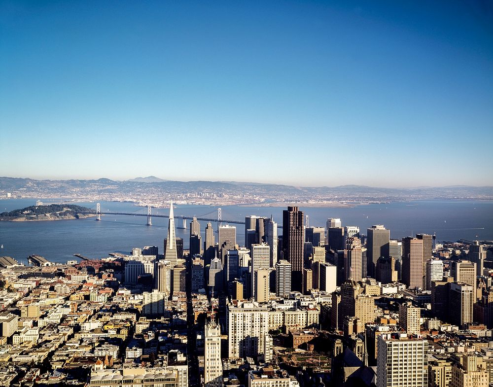 Aerial view of San Francisco with the San Francisco-Oakland Bay Bridge in the distance. Original image from Carol M.…