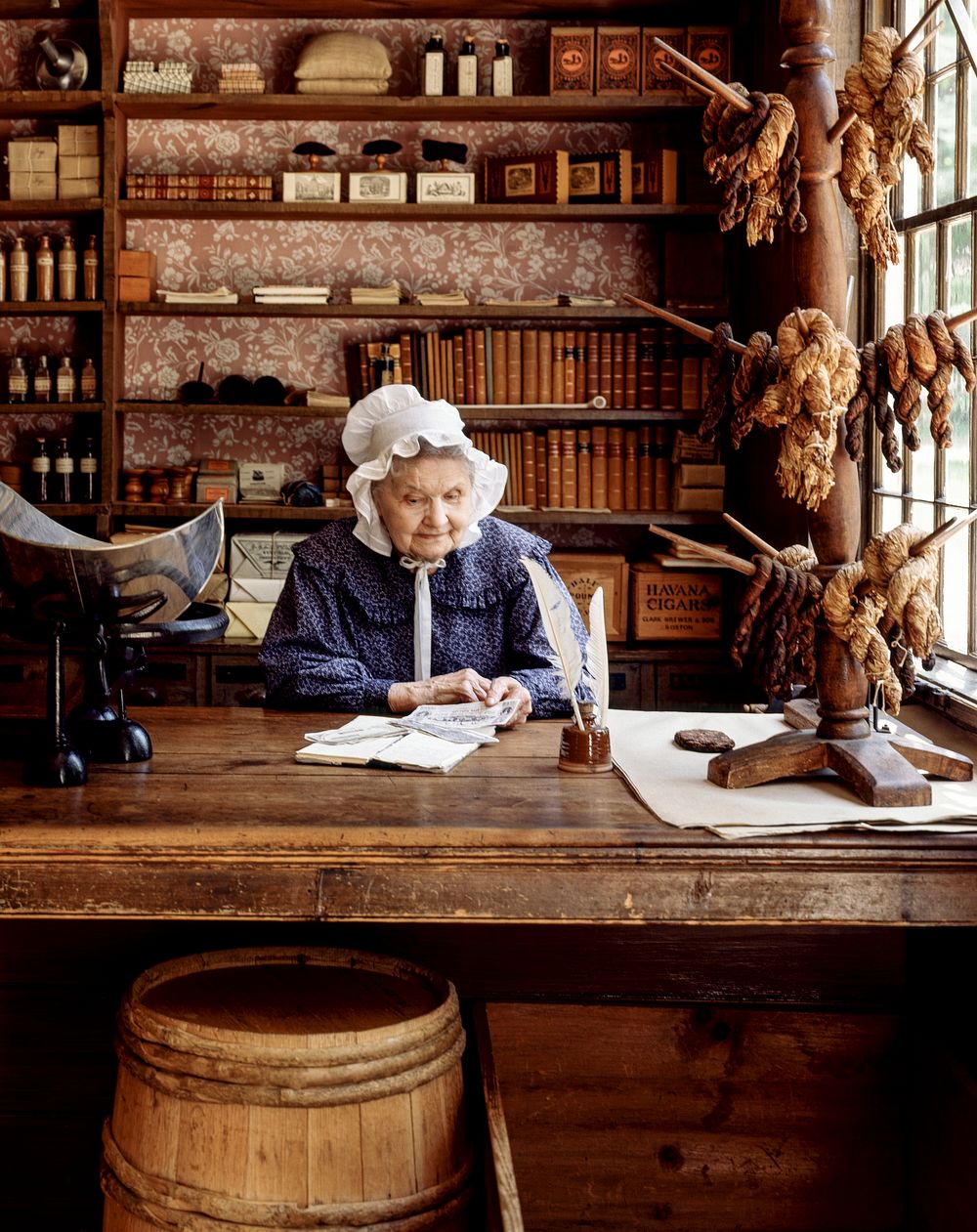 Costumed clerk in the store at Old Sturbridge Village in Sturbridge, Massachusetts. Original image from Carol M.…