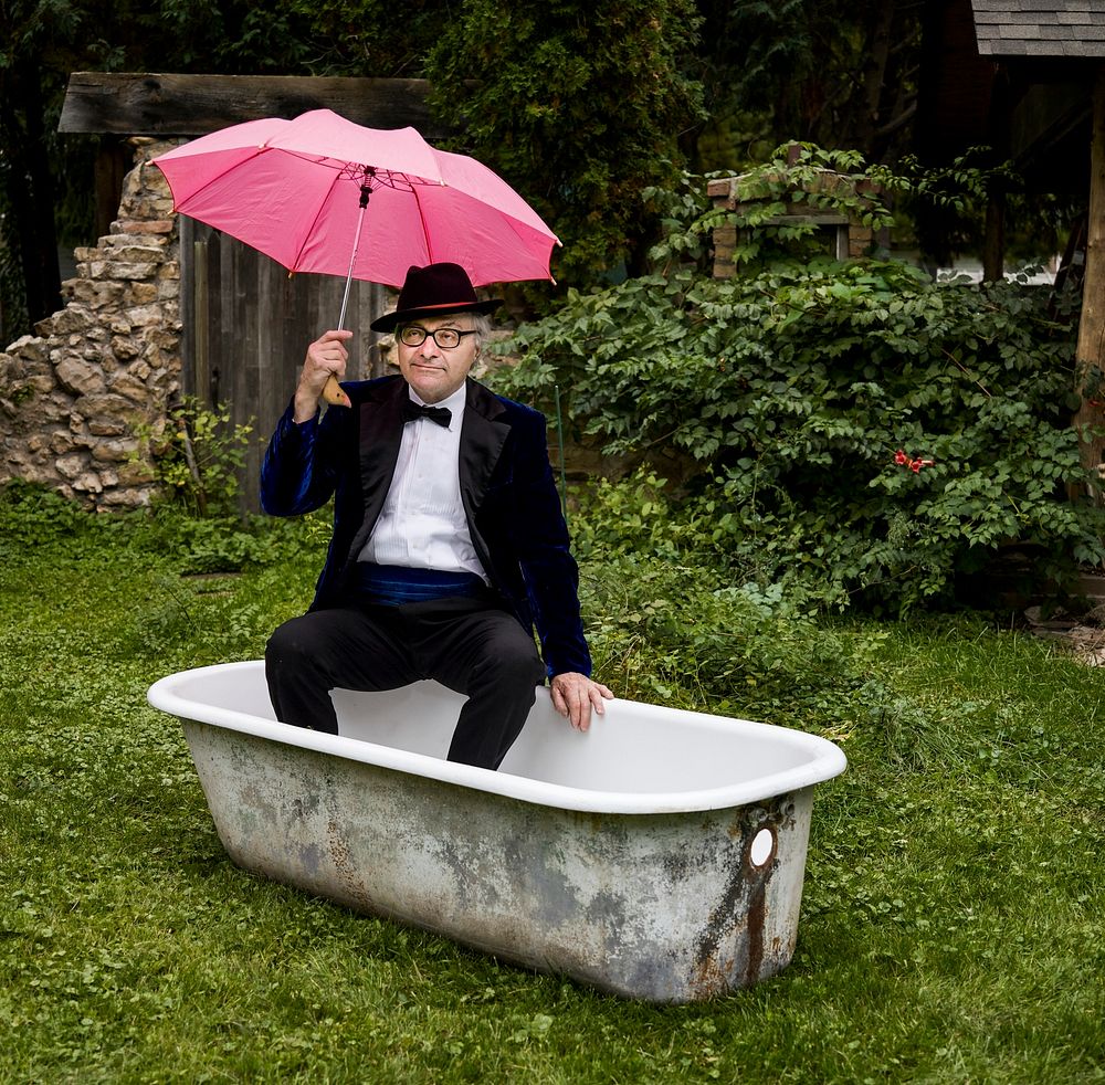 Retired gentleman with pink umbrella in a tub. Original image from Carol M. Highsmith&rsquo;s America, Library of Congress…