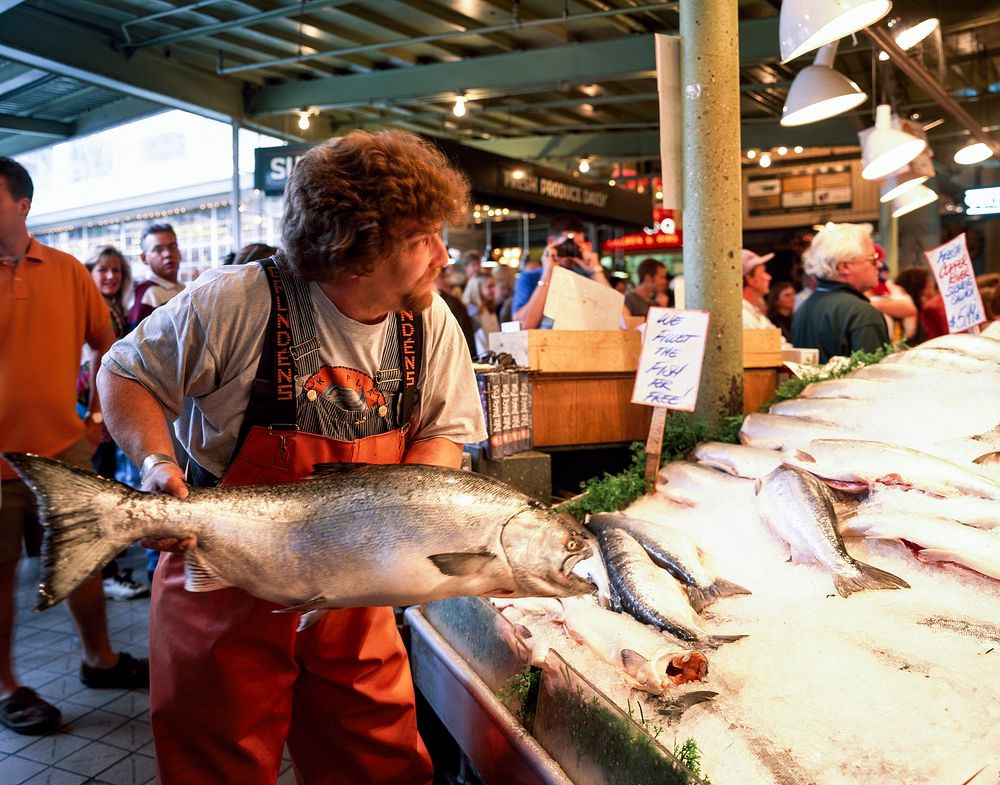 A fish thrower at the Pike Place Fish Company in Seattle, Washington state. Original image from Carol M. Highsmith&rsquo;s…