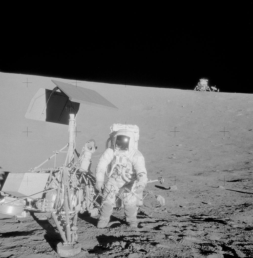 Astronaut Charles Conrad Jr., commander, examines the unmanned Surveyor 3 spacecraft during the second Apollo 12…