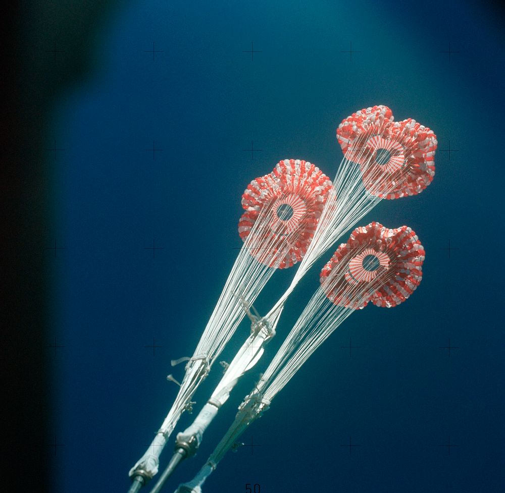 The three main ring sail parachutes of the Skylab 3 command module as they unfurl during descent to a successful splashdown…