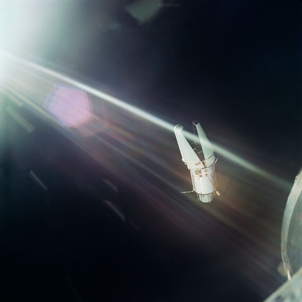 The Augmented Target Docking Adapter is photographed against the background of the blackness of space from the Gemini-9…