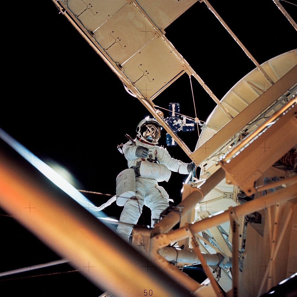Astronaut Owen K. Garriott, Skylab 3 science pilot, retrieves an imagery experiment from the Apollo Telescope Mount (ATM)…