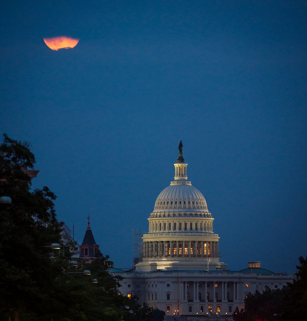 A perigee full moon or supermoon is seen behind clouds over the United States Capitol, Sunday, August 10, 2014, in…