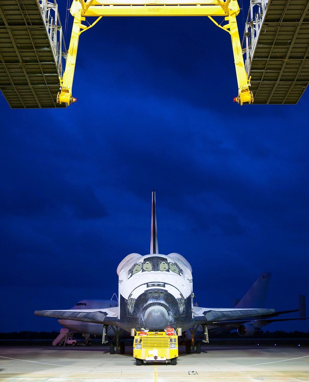 Space shuttle Discovery is towed into position at the mate-demate device, at the Shuttle Landing Facility, at NASA&rsquo;s…