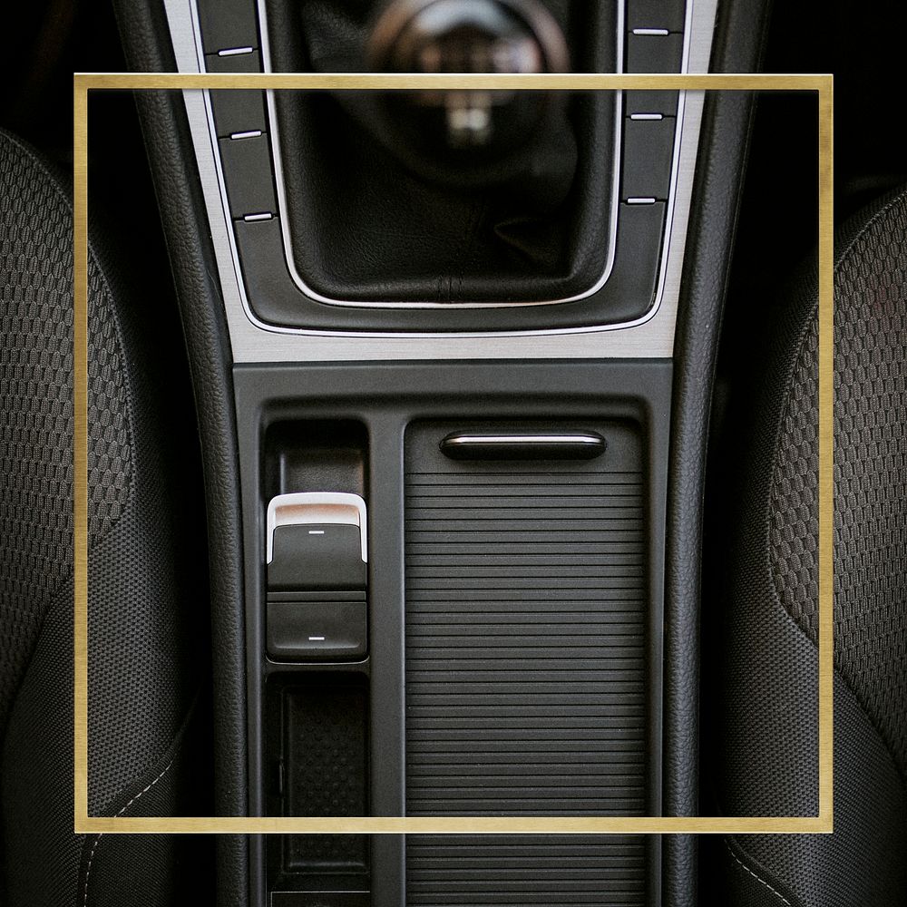 Gold square frame on a black car center console space