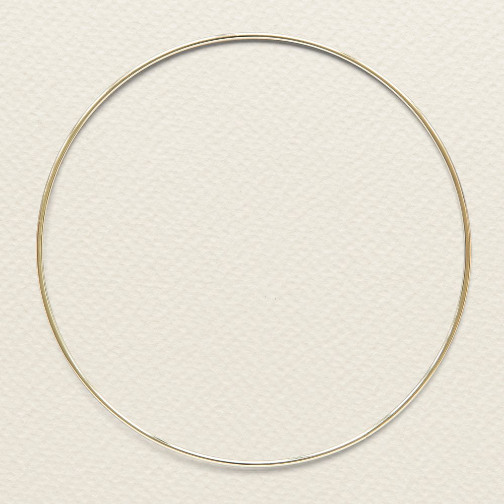 Round gold frame on beige background