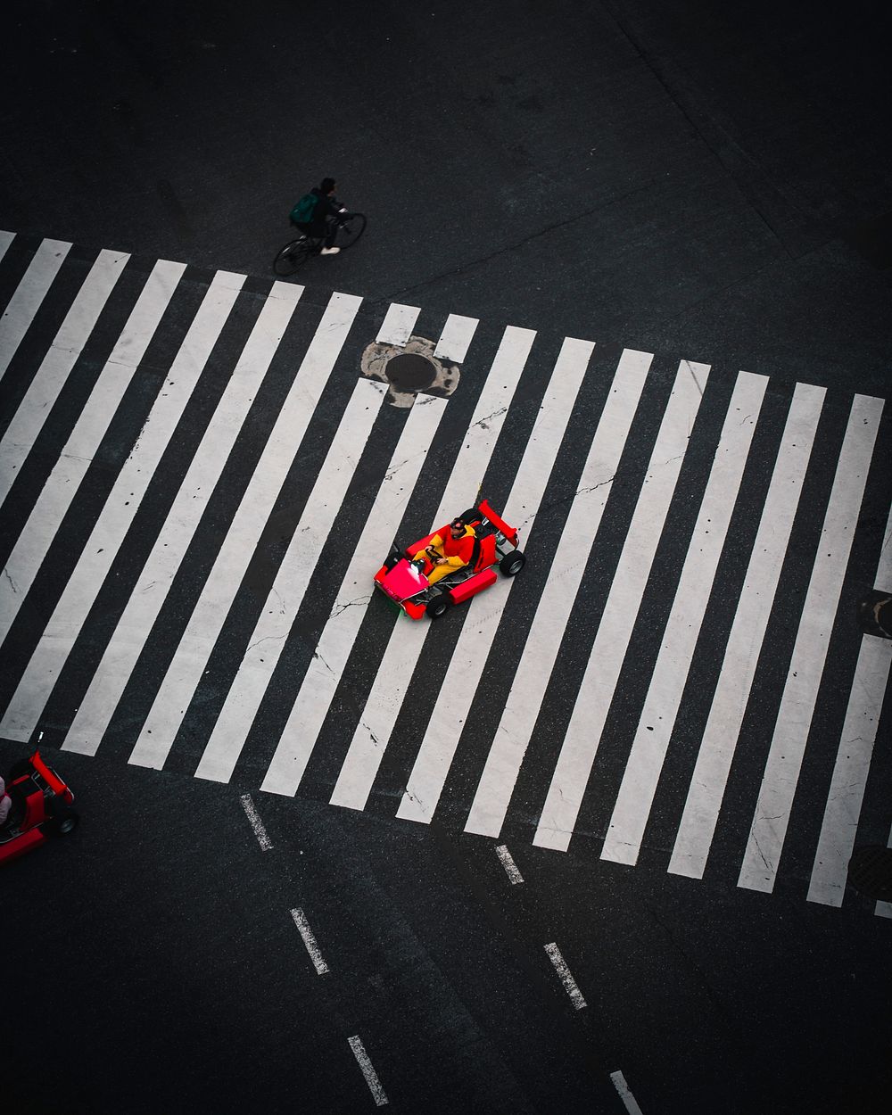 Red go-karts on a crosswalk in Japan