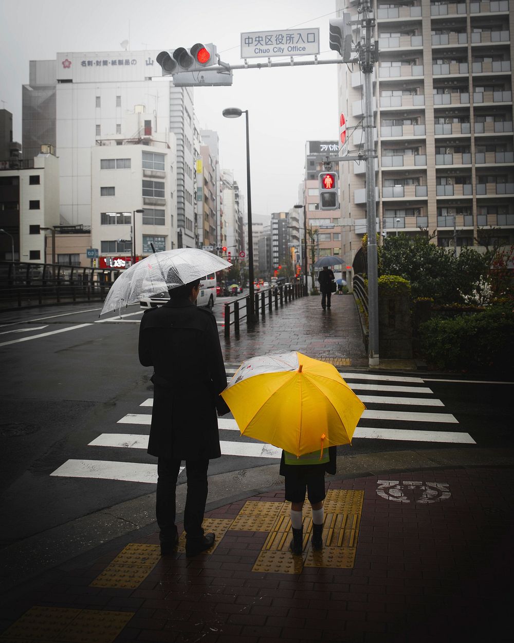 Father and son in a rainy Tokyo