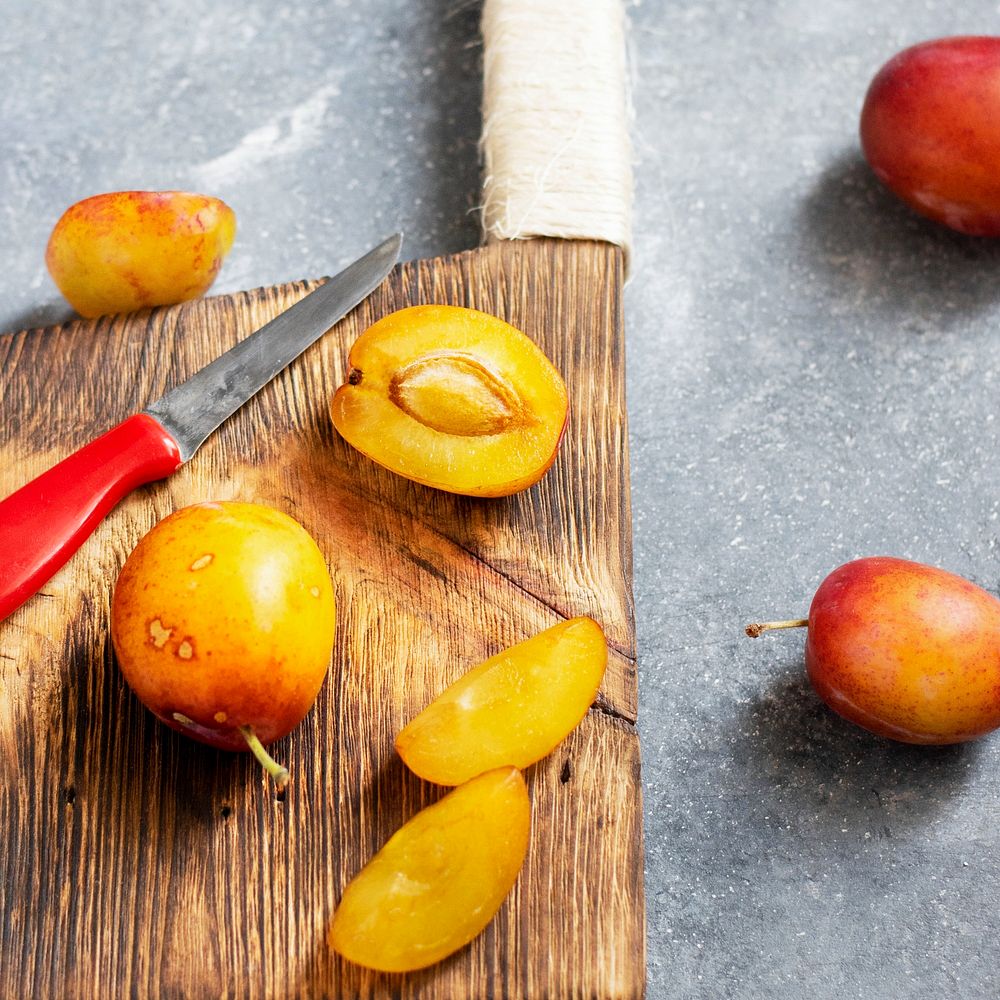 Fresh ripe plums on a cutting board