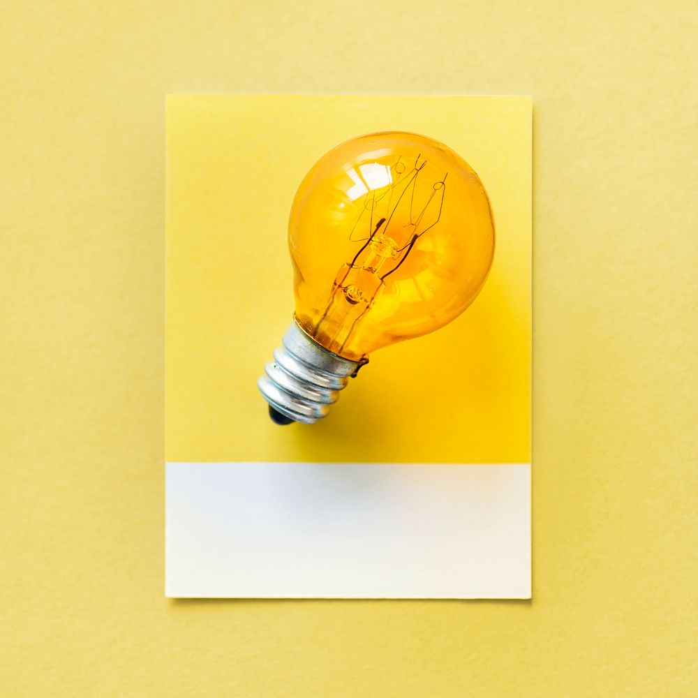 Yellow light bulb on a yellow  paper
