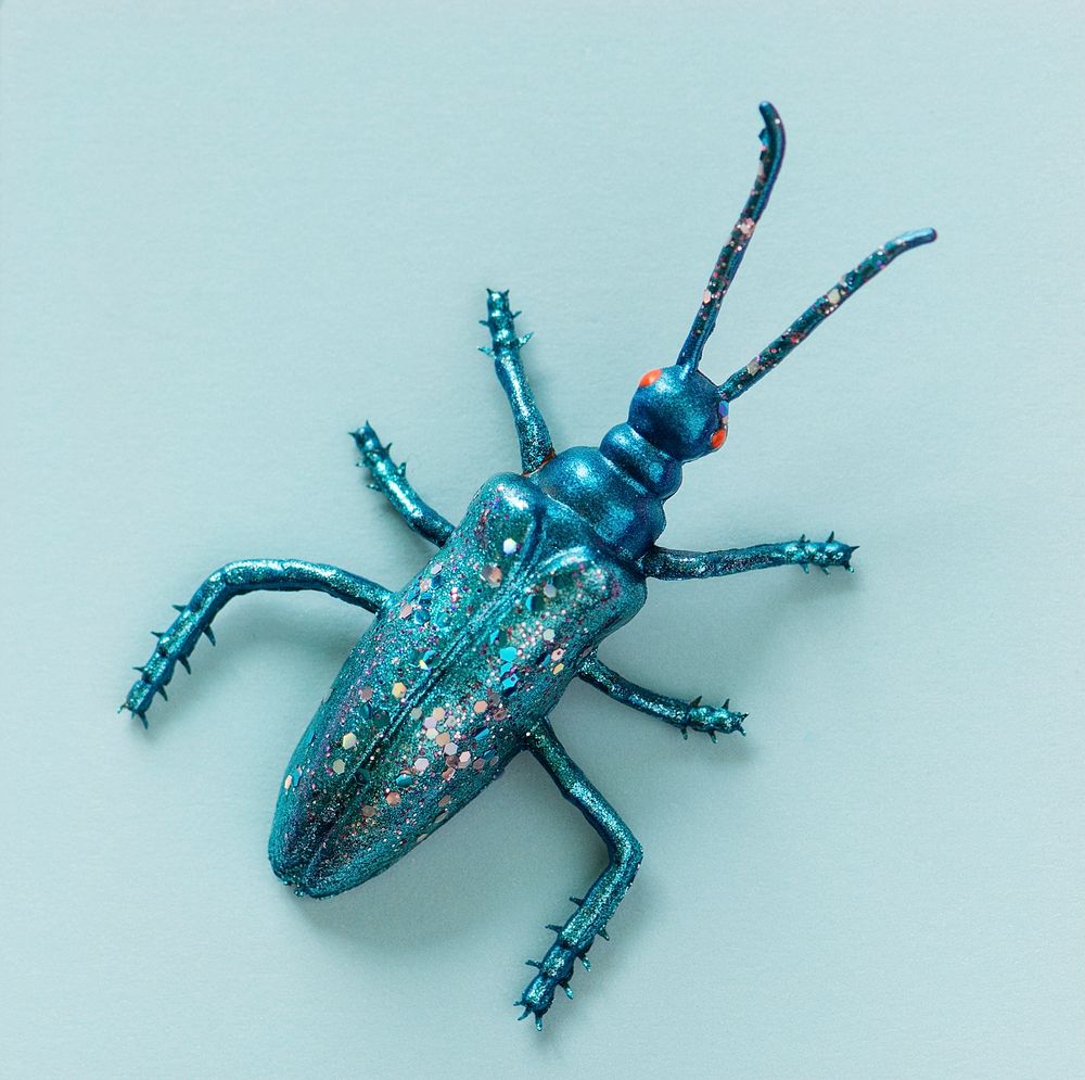 Colorful miniature bug on a paper
