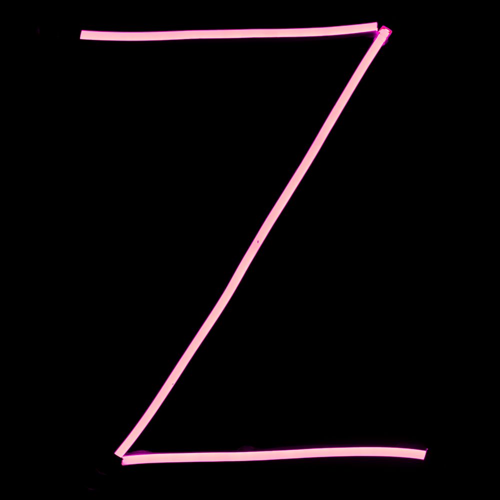 Alphabet pink neon lights on black background