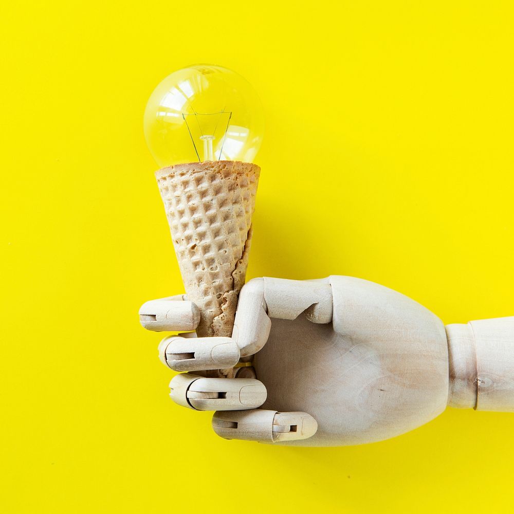 Robot hand holding a light bulb ice cream