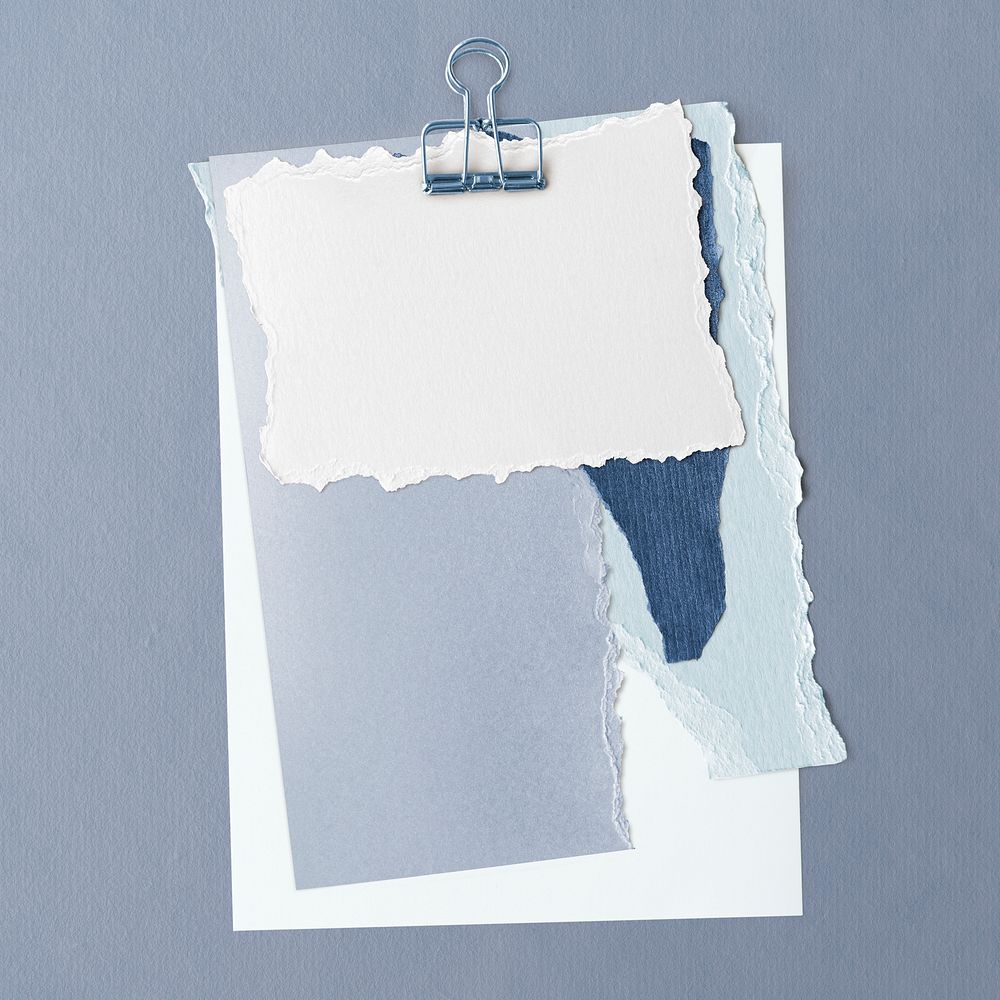 Blank torn blue paper templates set with a paperclip