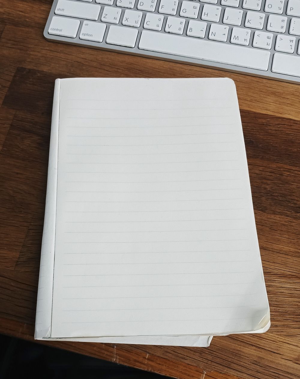 Blank notebook on a wooden table mockup