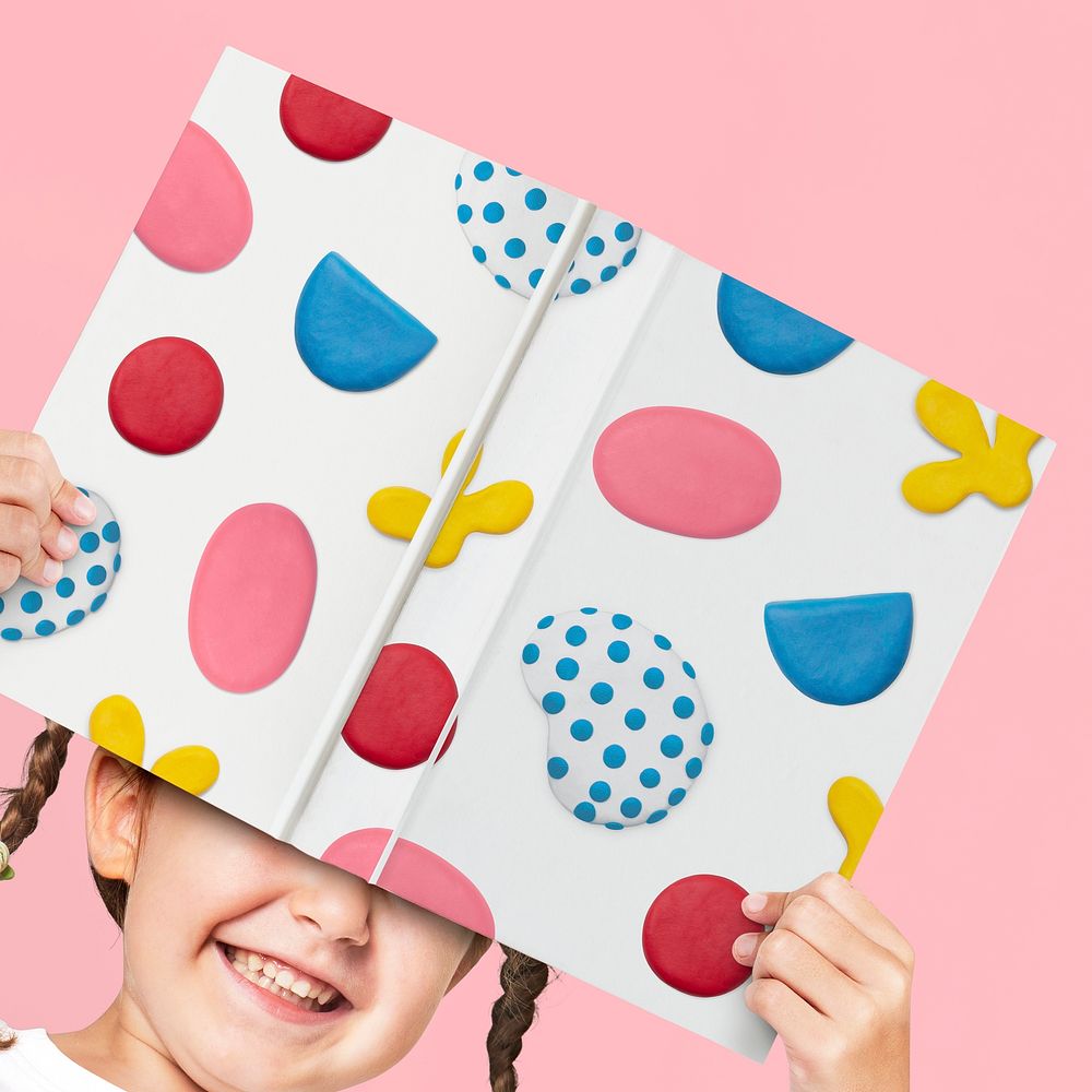 Cute clay patterned children’s book cover held by a girl