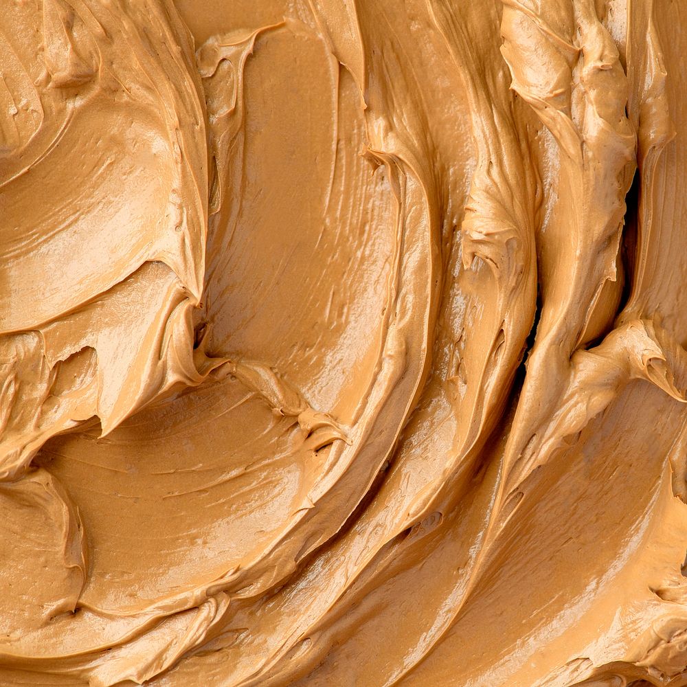 Caramel frosting texture background close-up