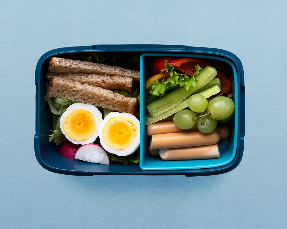 Healthy kids food lunchbox with egg and greens