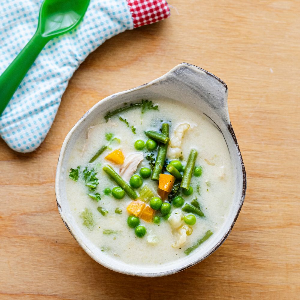 Kids healthy chicken soup with peas and carrots 