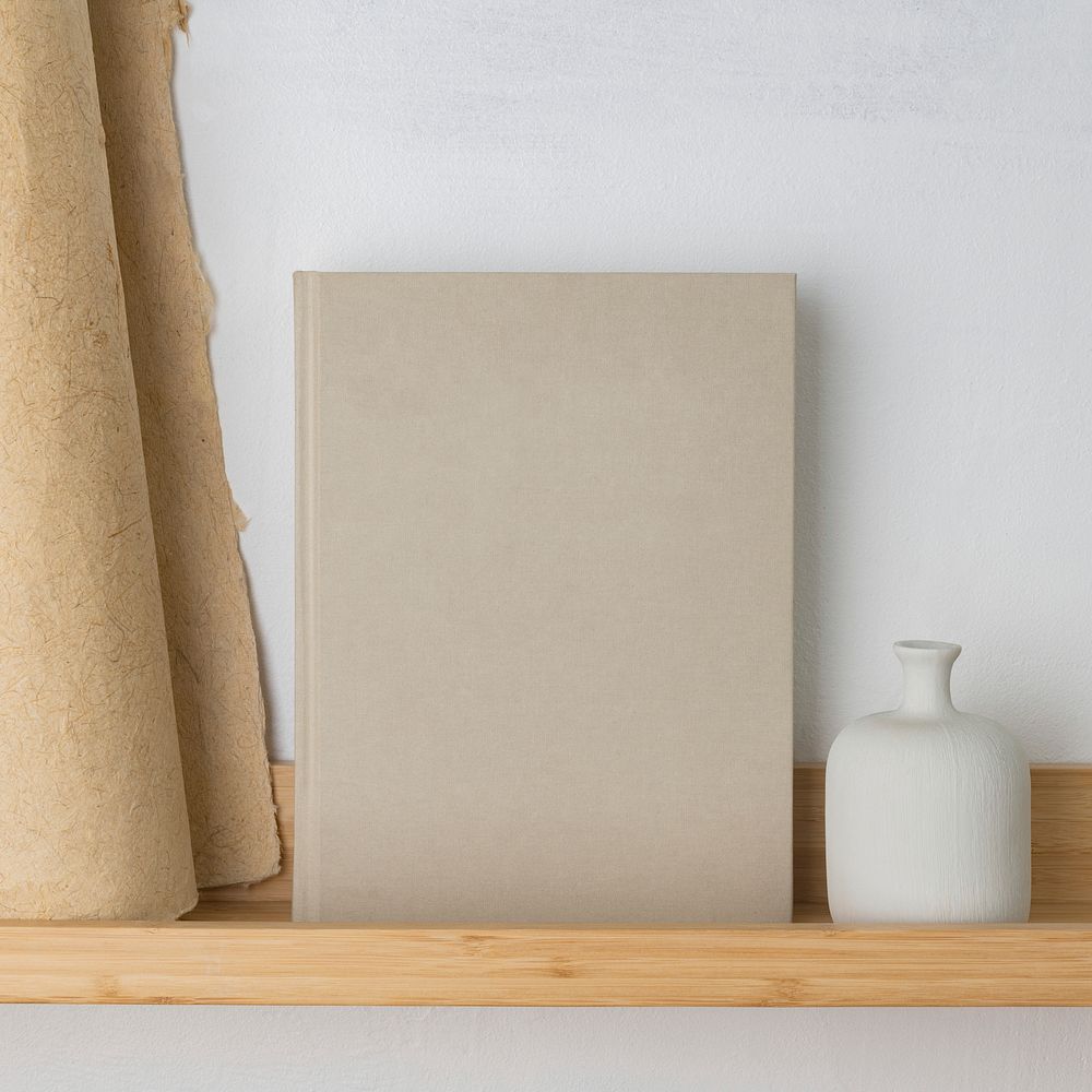 Blank book on wooden shelf, minimal home interior