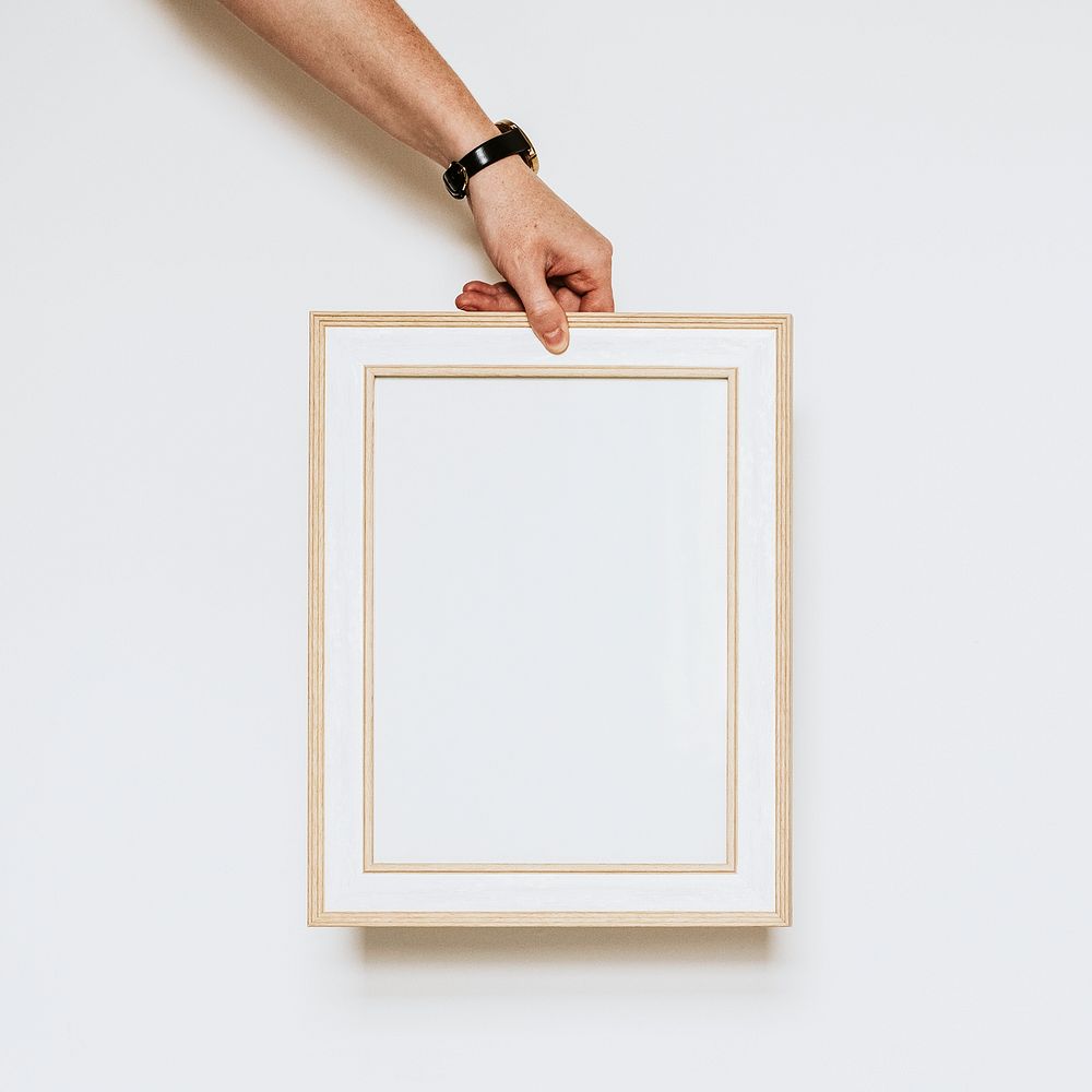 Man holding empty wooden frame, with design space
