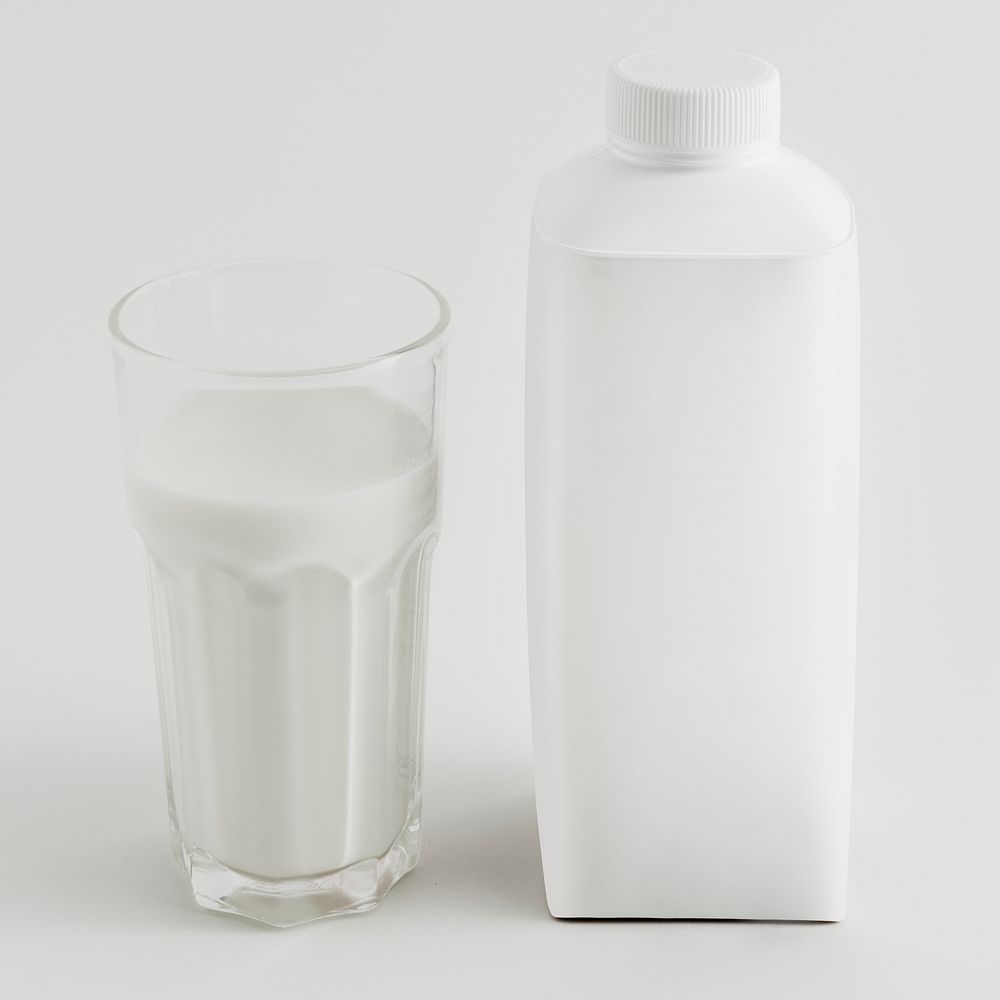 Fresh milk in a glass with a bottle