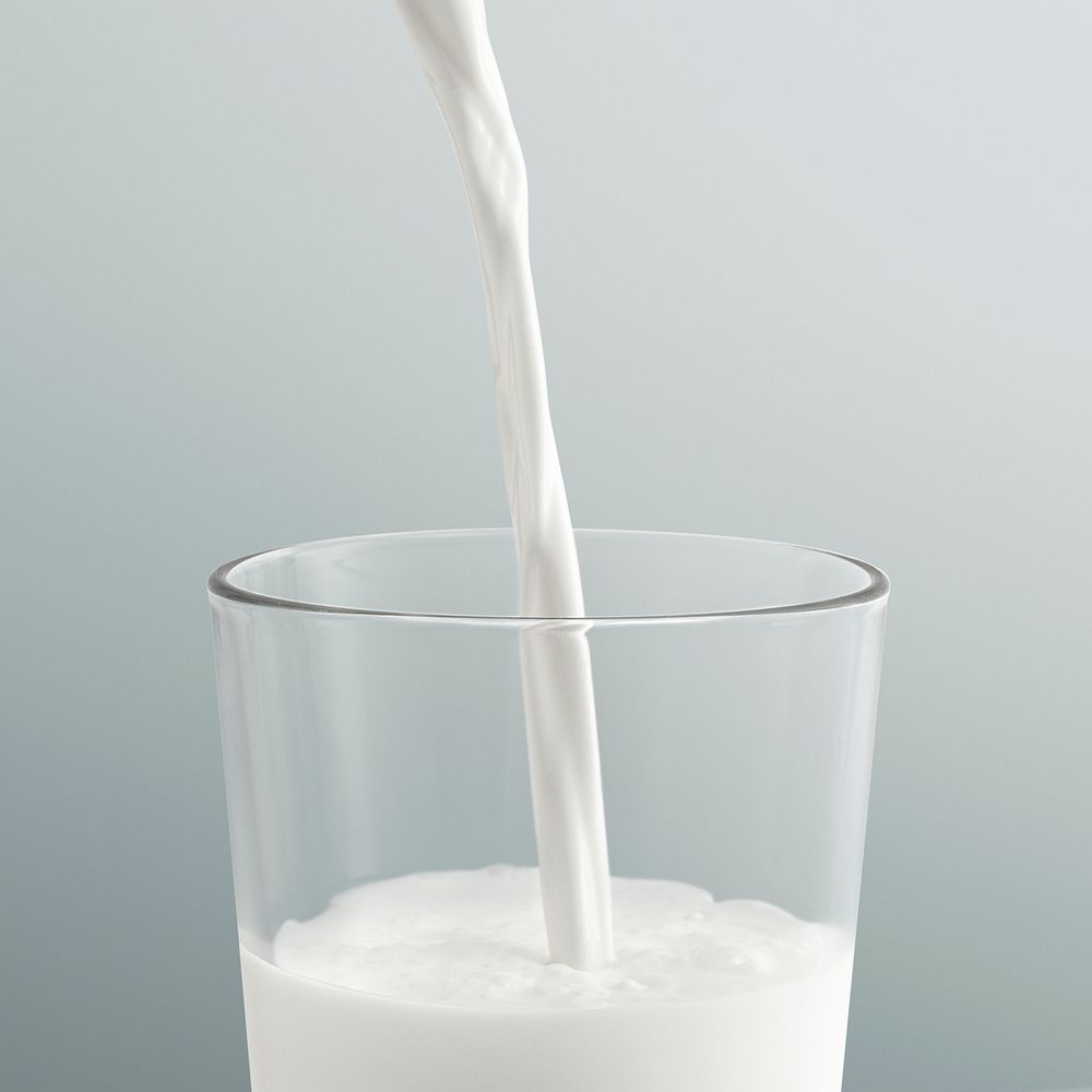 Close up of pouring milk into a glass