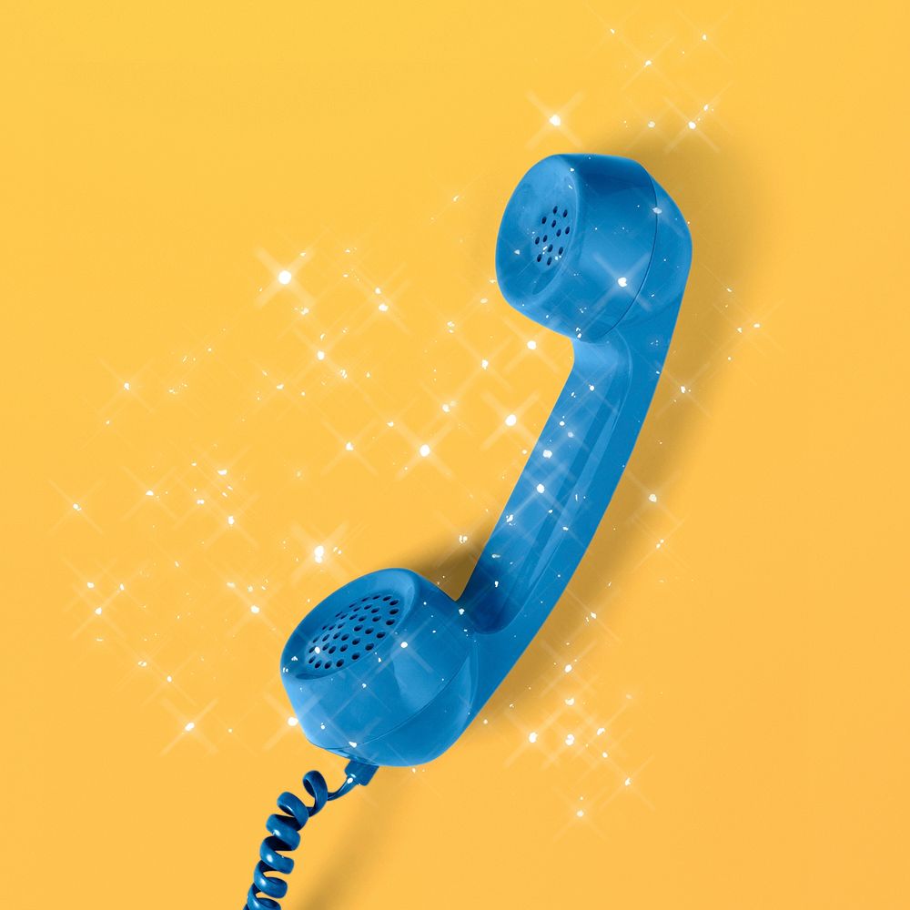Sparkling retro blue corded phone on a yellow background