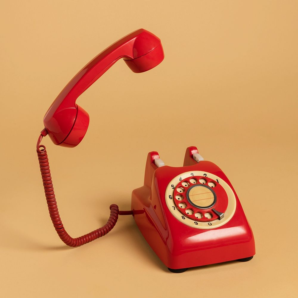 Red rotary dial on a beige background 
