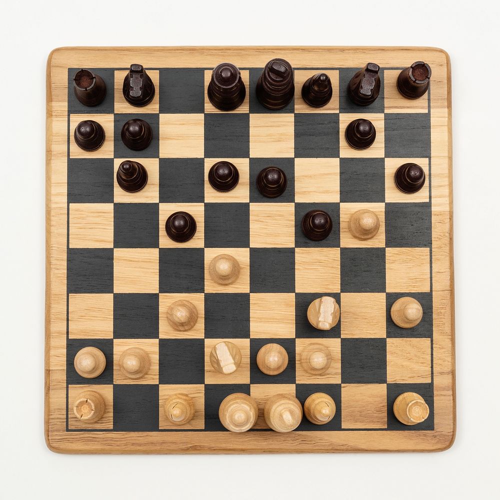 Wooden chess board on an off white background