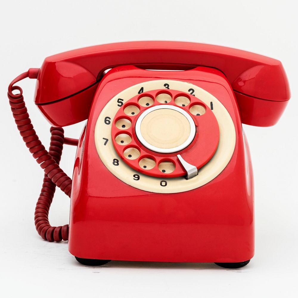 Vintage red telephone on white background