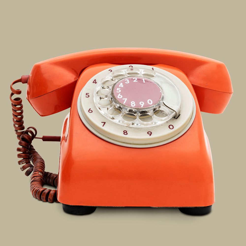 Vintage orange telephone on beige background