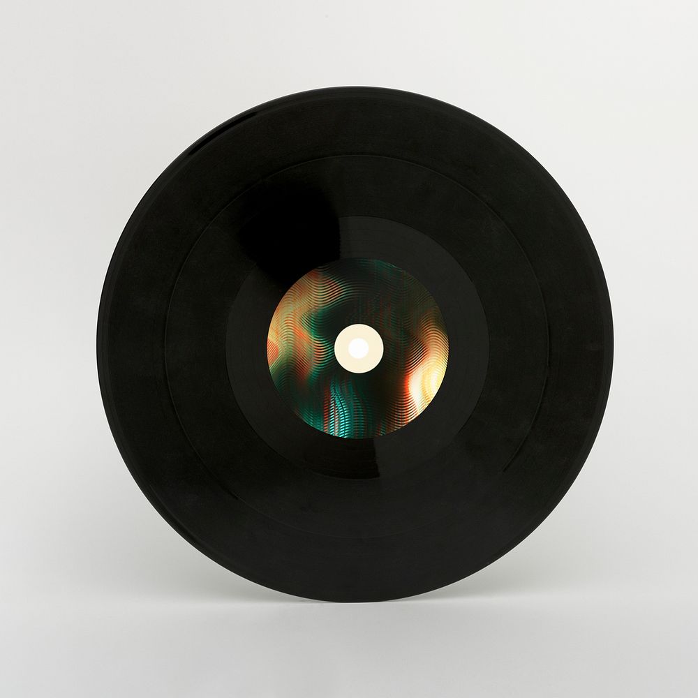 Black vinyl record on a gray background