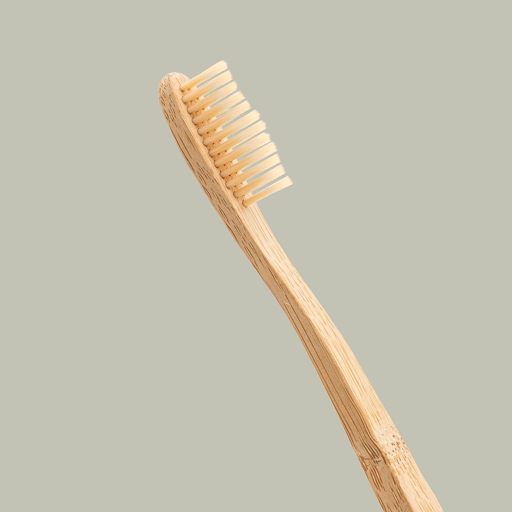 Natural bamboo toothbrush on gray background
