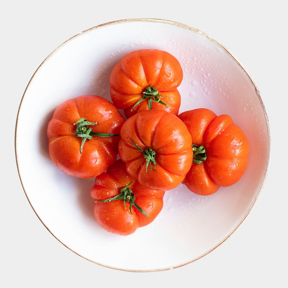 Natural fresh organic tomatoes in white bowl