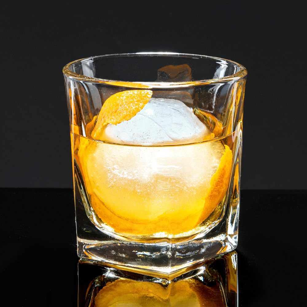 Liquour with an orange peel cocktail