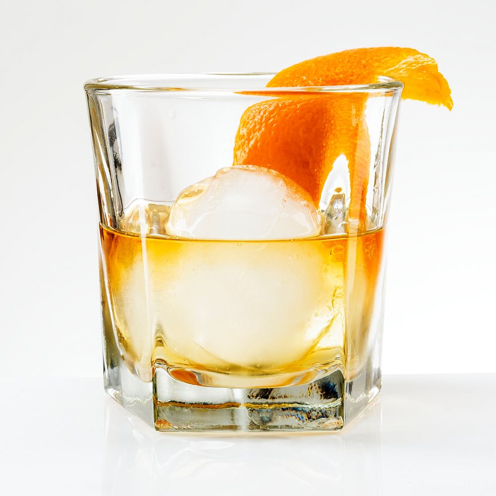 Liquour with an orange peel cocktail