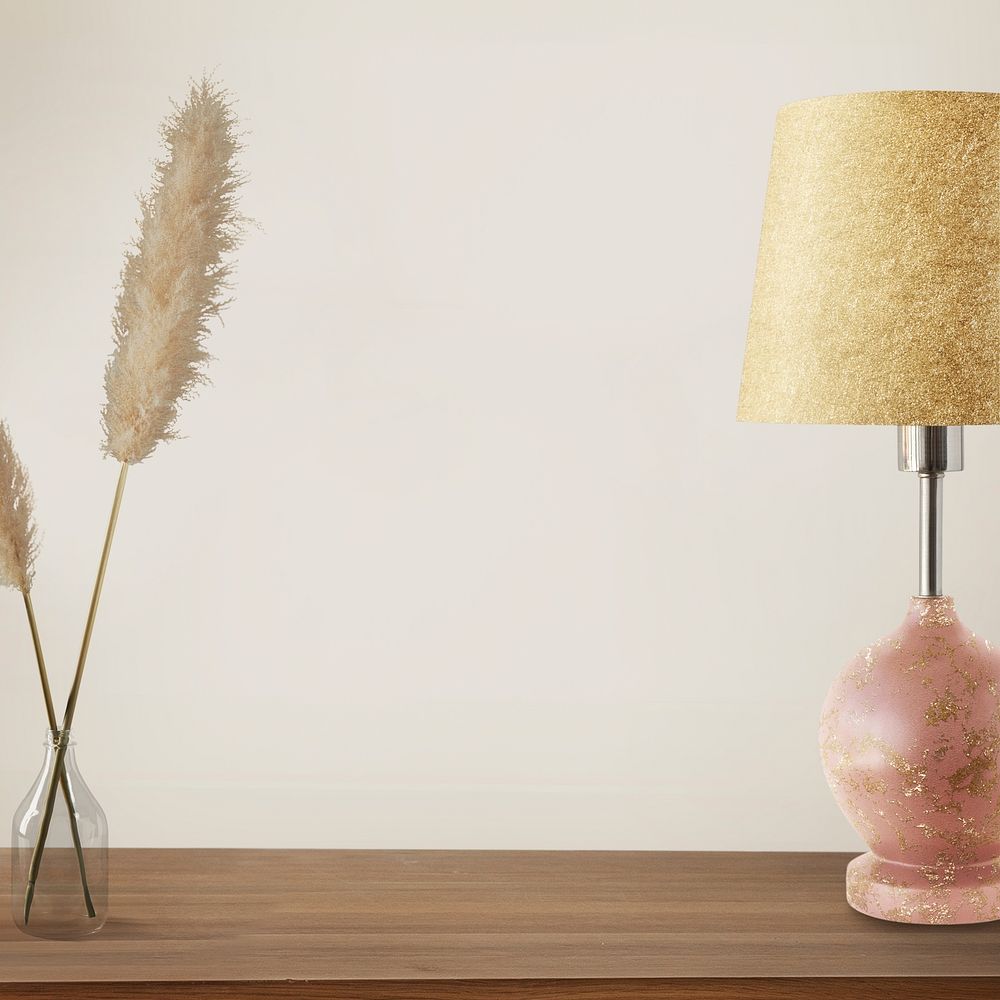 Pink lamp with vase on a wooden table