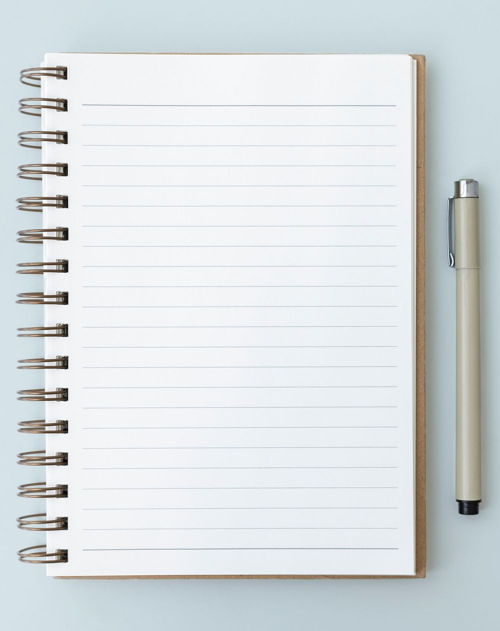 Blank plain white notebook page with a pen