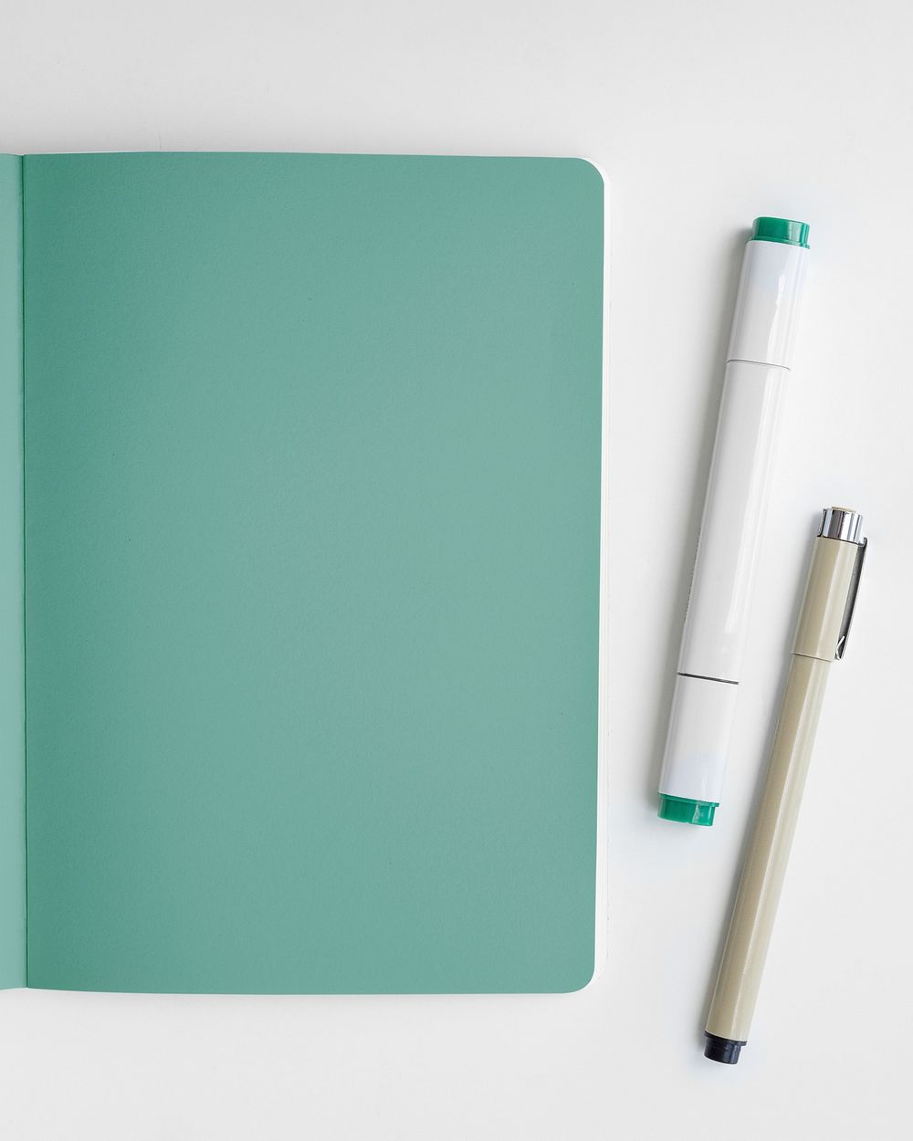 Blank plain green notebook page with a pen mockup