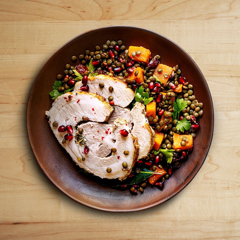 Roasted Christmas ham with pomegranate and lentils flatlay food photography